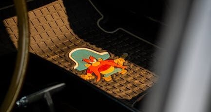 A set of custom-fit all-weather TPE floor mats inside a modern electric vehicle with raised edges