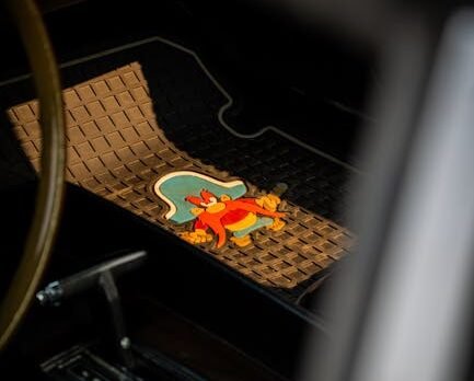 A set of custom-fit all-weather TPE floor mats inside a modern electric vehicle with raised edges