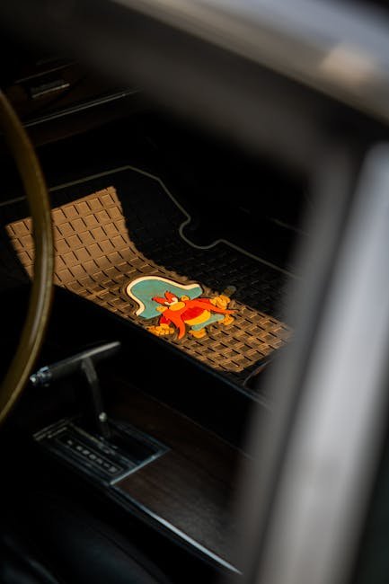 A set of custom-fit all-weather TPE floor mats inside a modern electric vehicle with raised edges