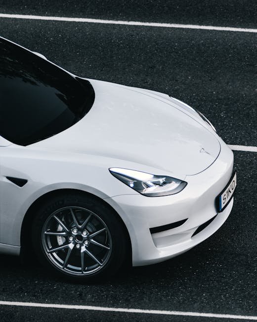 Close-up of premium aluminum and rubber EV pedal covers installed in a Tesla Model 3, showing the anti-slip surface and sleek design