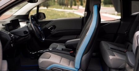 Detailed view of high-quality, custom-fit perforated leatherette EV seat covers installed in a luxury electric vehicle cabin