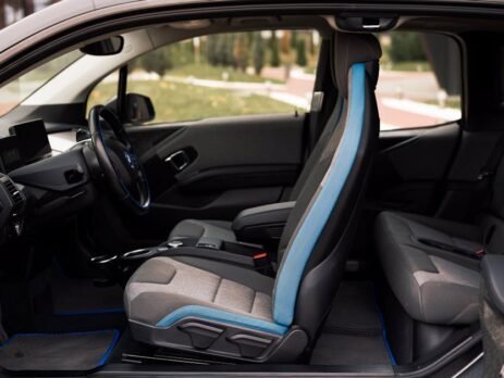 Detailed view of high-quality, custom-fit perforated leatherette EV seat covers installed in a luxury electric vehicle cabin