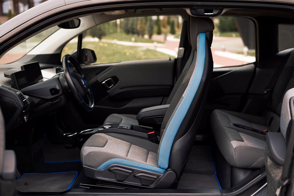Detailed view of high-quality, custom-fit perforated leatherette EV seat covers installed in a luxury electric vehicle cabin
